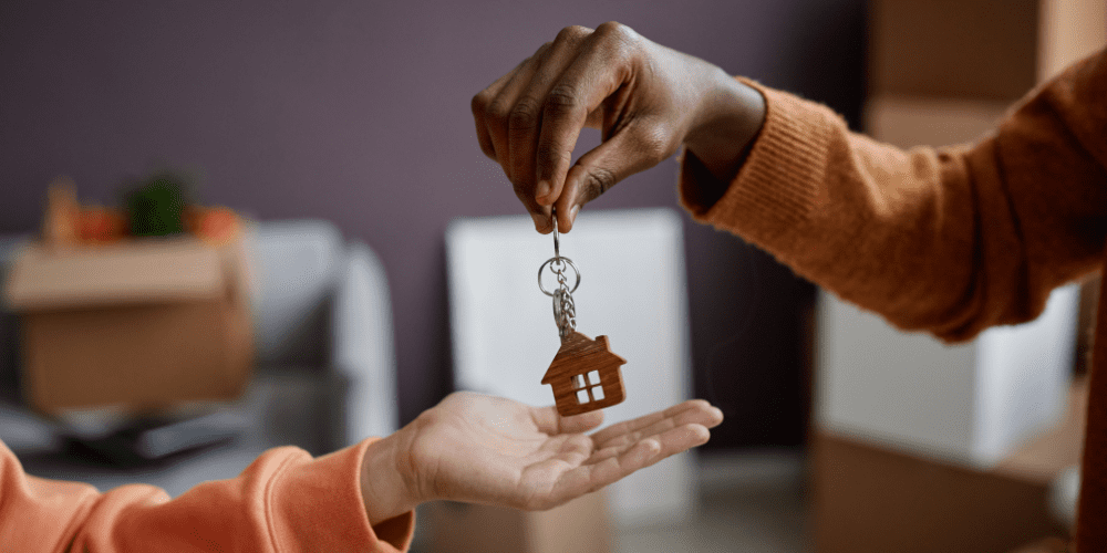 House key being passed between two people