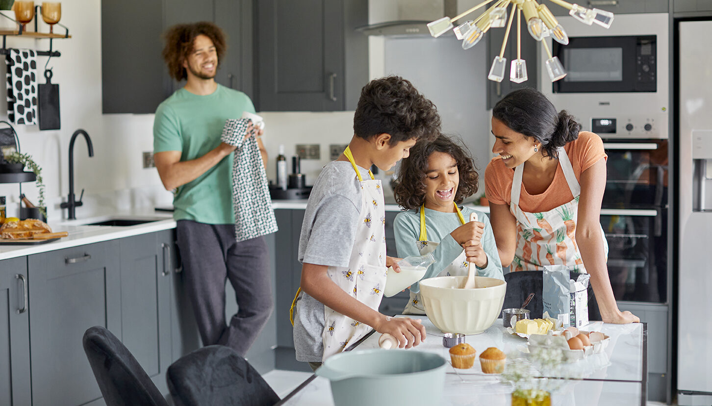 Family in the kitchen baking in a new build home