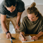 Couple writing a moving house checklist