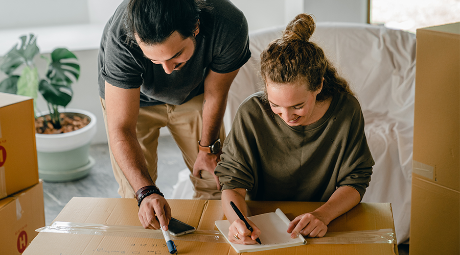 Couple writing a moving house checklist