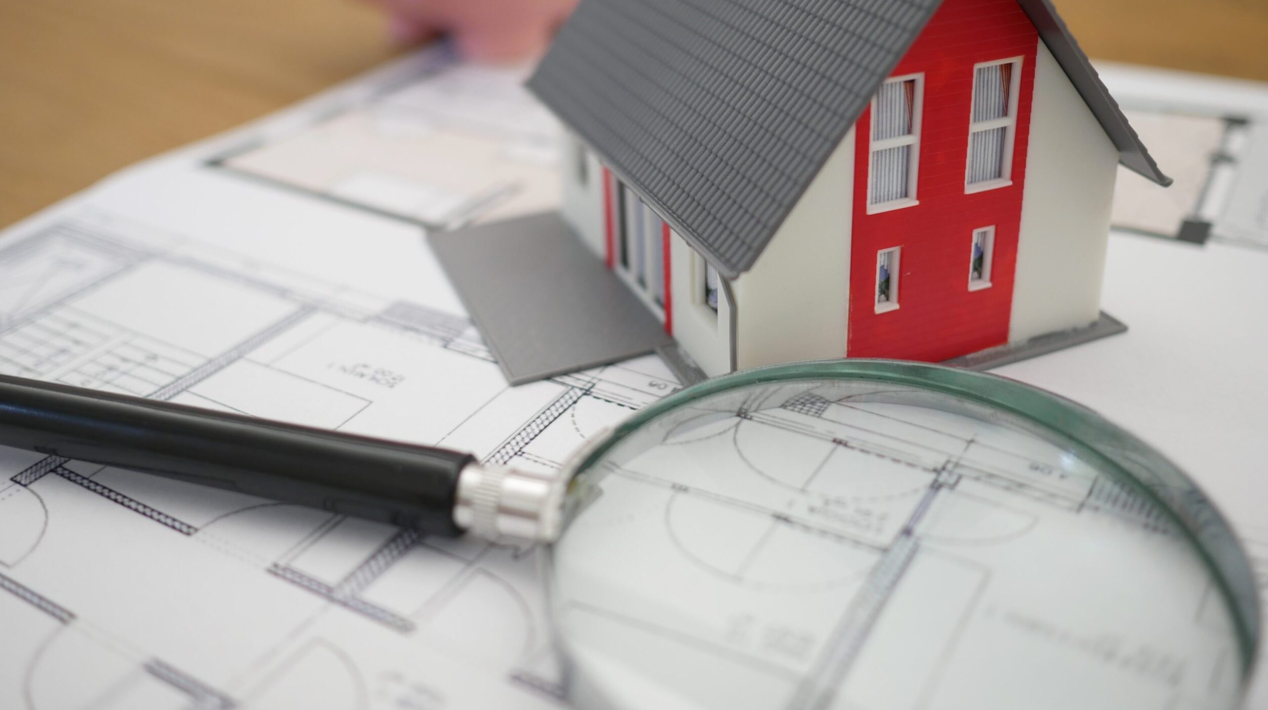 Magnifying glass on house plans